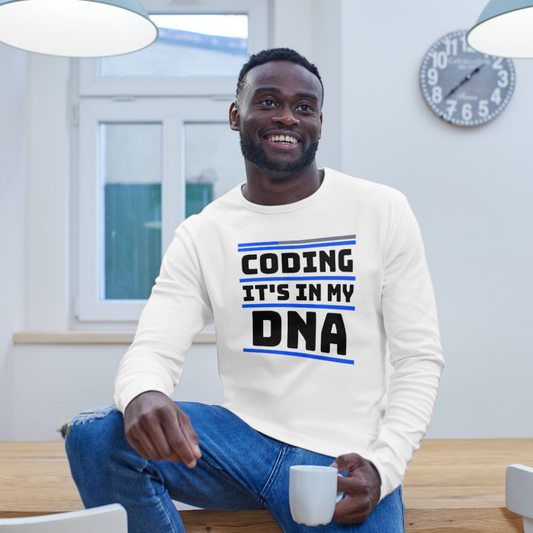 Man wearing a white shirt with 'Coding It's in My DNA' text, sitting indoors.