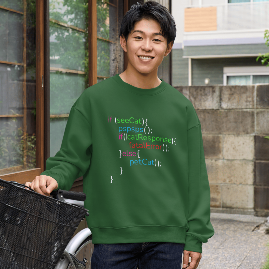 Person wearing a green sweatshirt with code-style text, standing outdoors.