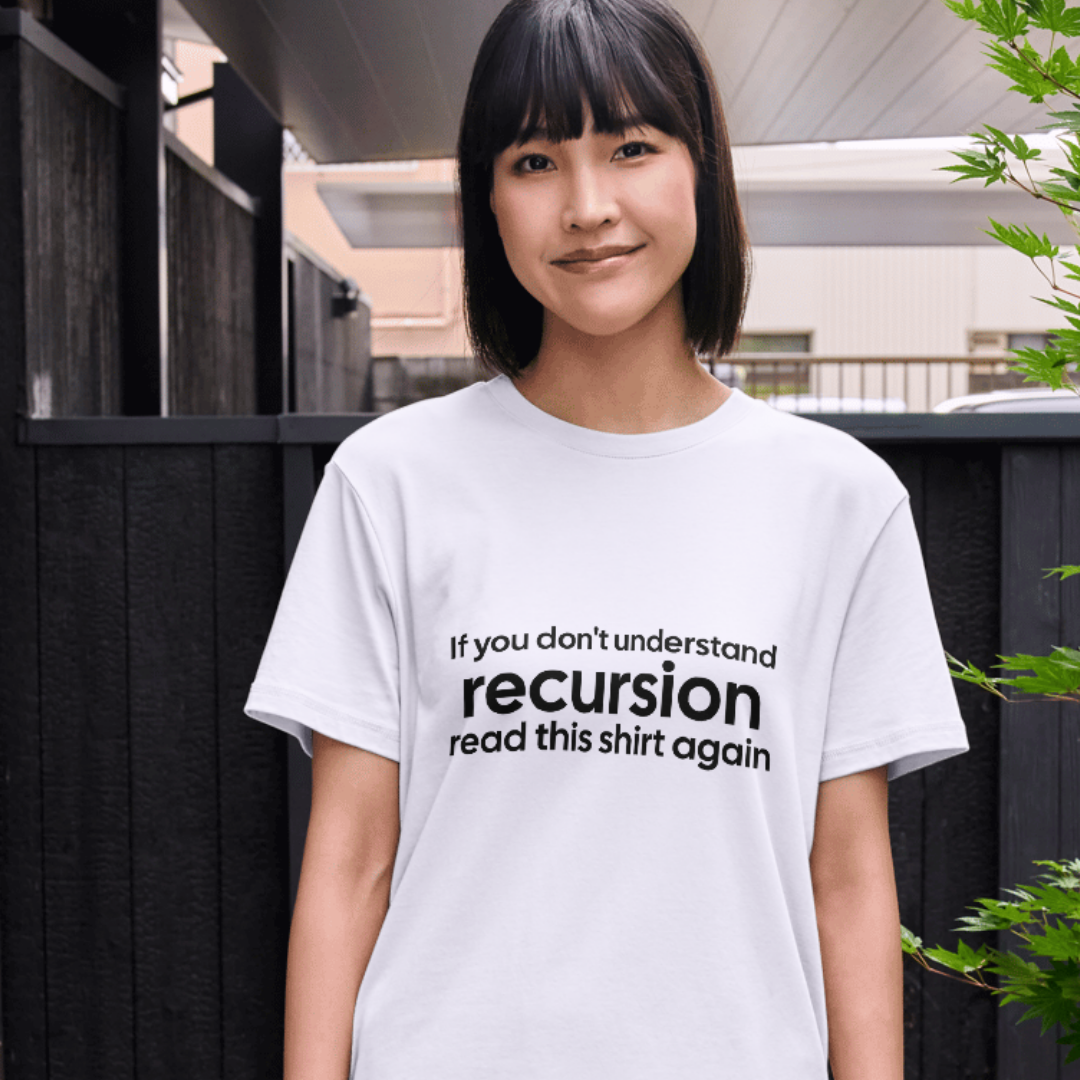 Person wearing a white t-shirt with a humorous text design outdoors.