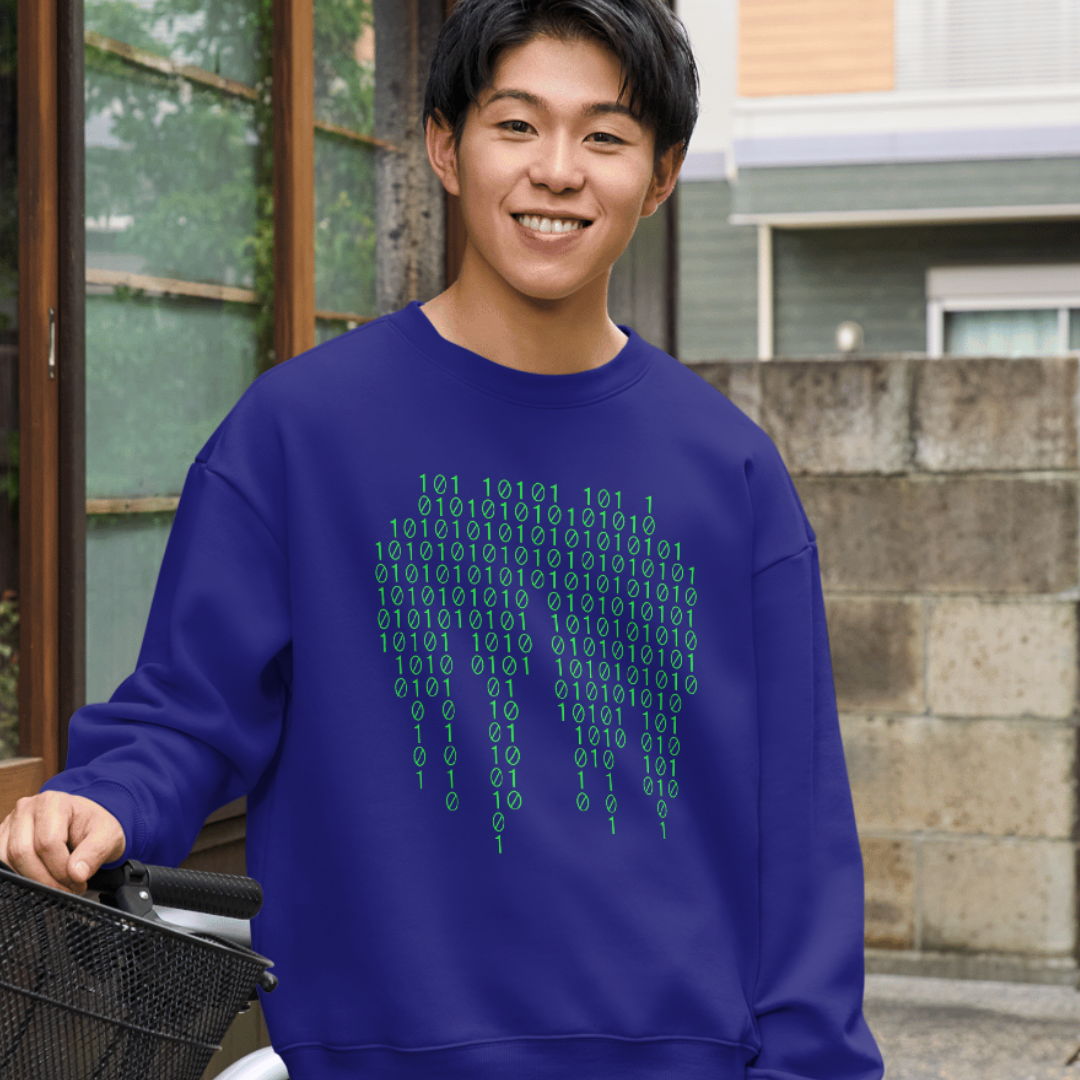 Person wearing a blue shirt with binary code design outdoors.
