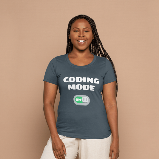 Woman wearing a blue t-shirt with 'CODING MODE ON' text on a beige background