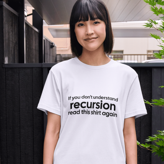Person wearing a white t-shirt with a humorous text design outdoors.