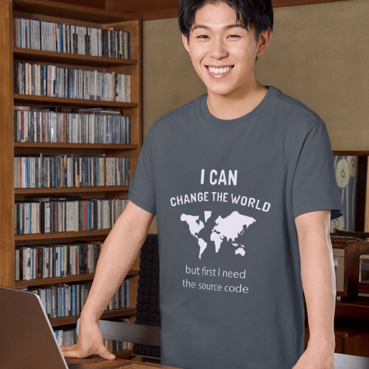 Person wearing a t-shirt with a motivational coding quote in front of a bookshelf.