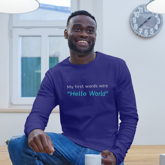 Man wearing a navy blue shirt with text, sitting indoors.