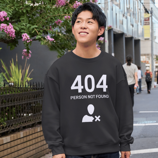 Person wearing a black shirt with '404 Person Not Found' text and icon on a street.